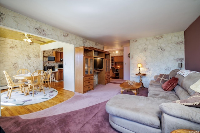 living room featuring ceiling fan and light hardwood / wood-style floors