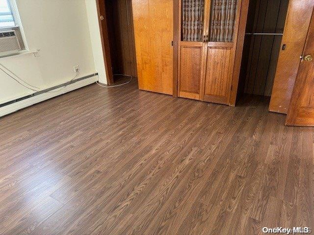 unfurnished bedroom featuring dark hardwood / wood-style floors