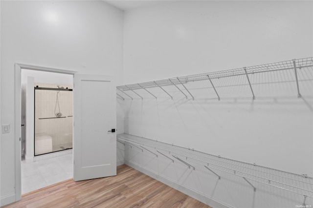 walk in closet featuring light hardwood / wood-style flooring