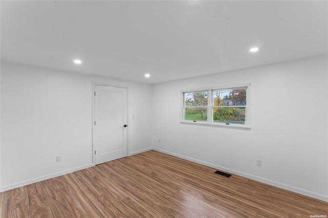 empty room with hardwood / wood-style floors