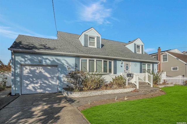 cape cod house featuring a garage and a front lawn