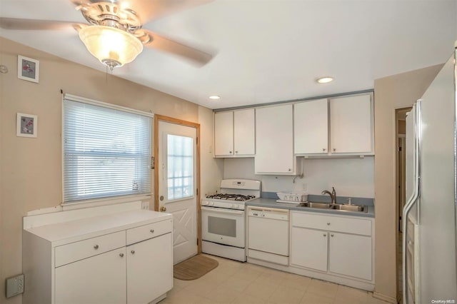 kitchen with white appliances, white cabinetry, ceiling fan, and sink