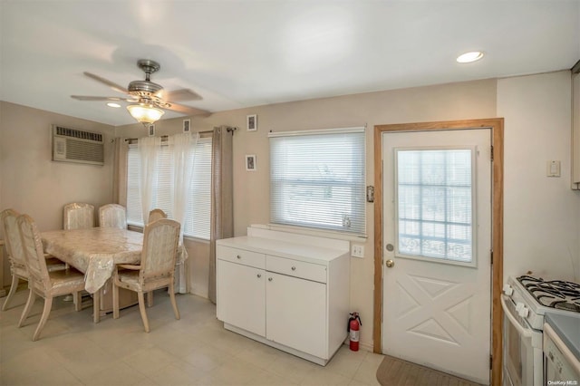 dining area featuring a wall mounted AC and ceiling fan