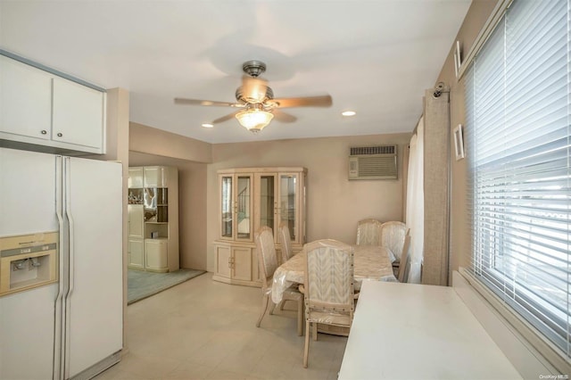 dining area with a wall mounted AC and ceiling fan