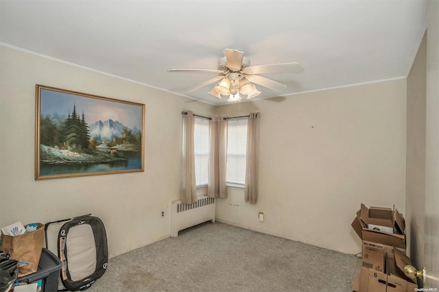 interior space with ceiling fan, ornamental molding, and radiator