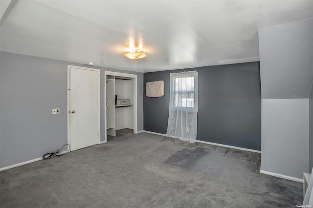 interior space with dark carpet and a closet