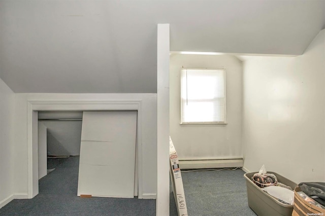 bonus room featuring dark carpet, lofted ceiling, and a baseboard heating unit