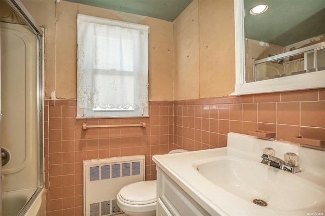 full bathroom featuring vanity, tile walls, and radiator