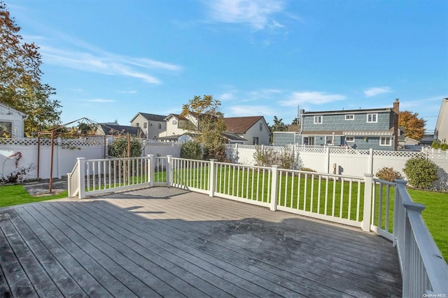 wooden deck featuring a lawn