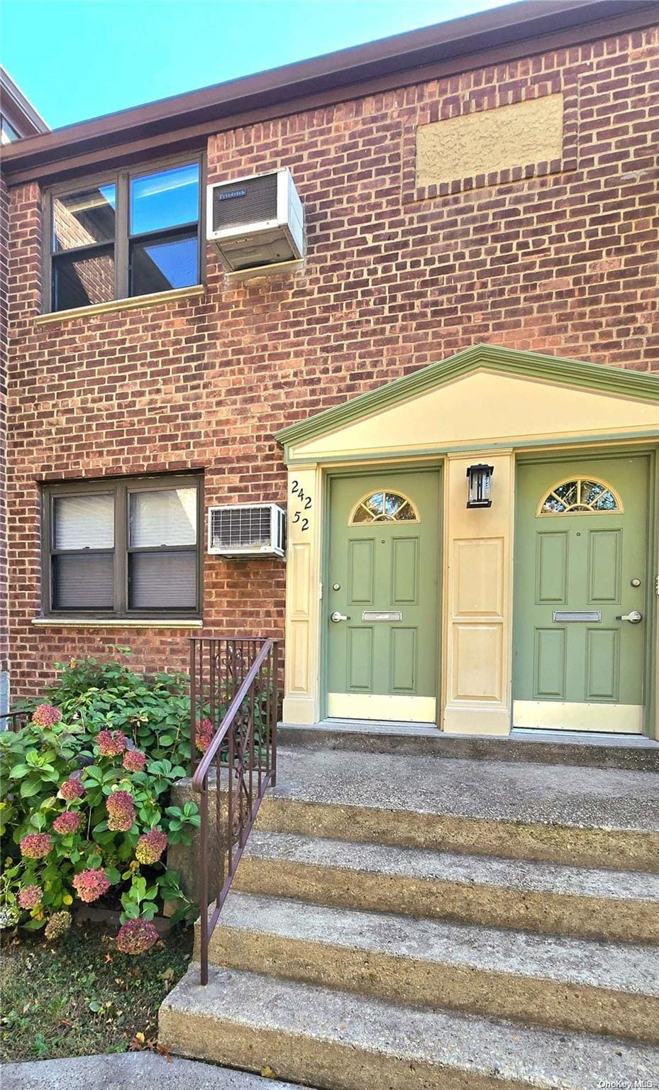 entrance to property featuring a wall mounted AC