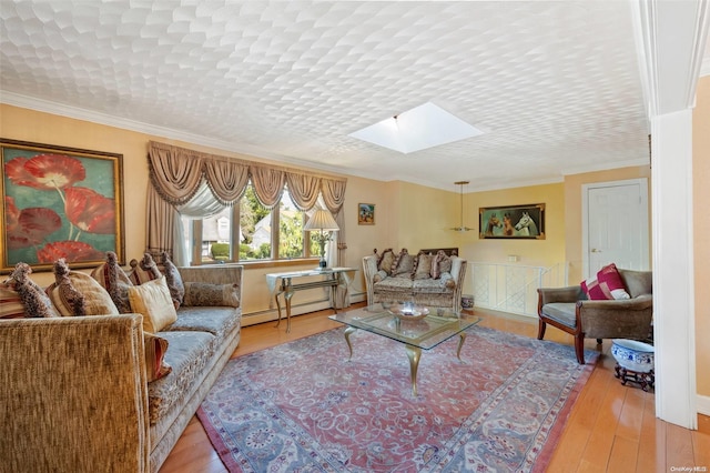 living room featuring light wood-type flooring, a skylight, a baseboard radiator, and ornamental molding