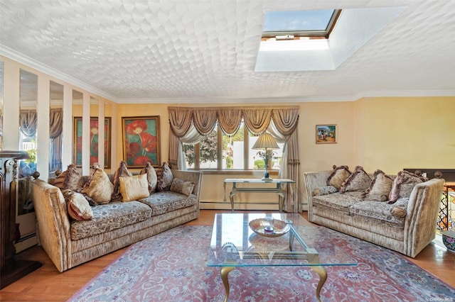 living room featuring wood-type flooring, a skylight, baseboard heating, and ornamental molding