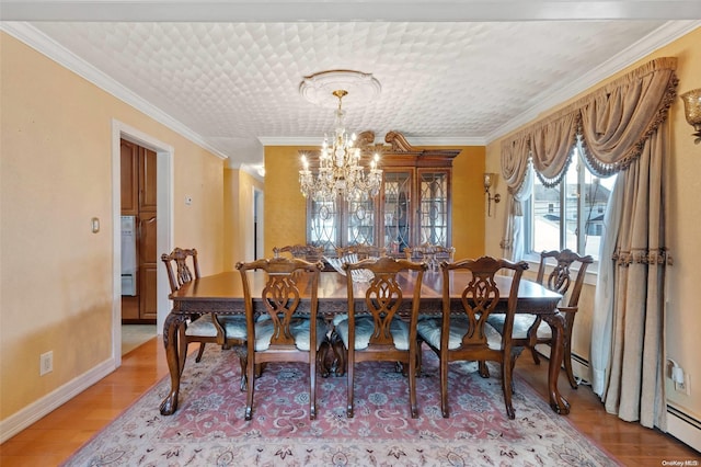 dining room with an inviting chandelier, wood-type flooring, and ornamental molding