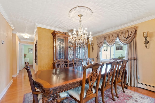 dining room featuring an inviting chandelier, light hardwood / wood-style flooring, ornamental molding, a textured ceiling, and baseboard heating