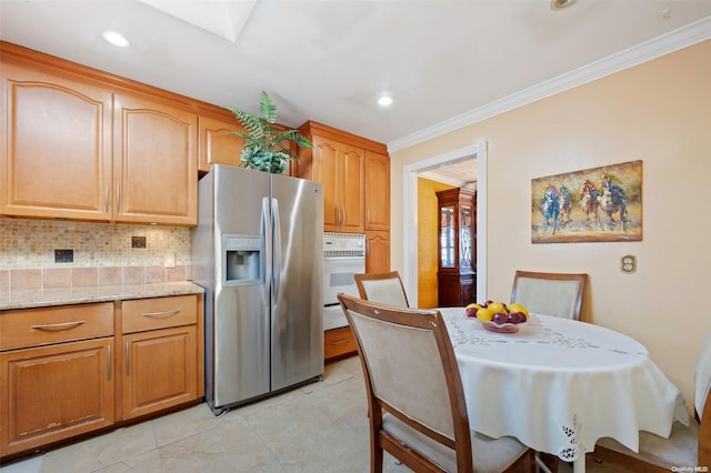 kitchen featuring white oven, tasteful backsplash, light stone counters, stainless steel refrigerator with ice dispenser, and crown molding