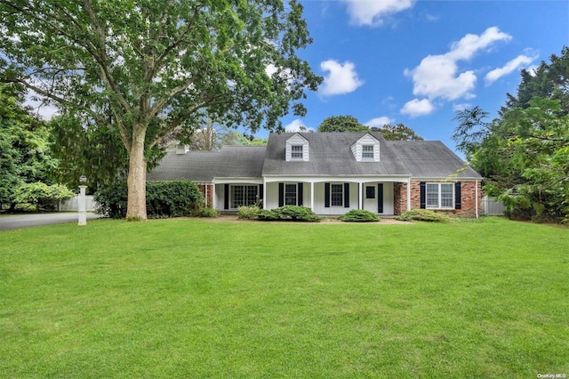 cape cod home with a front yard