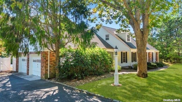 view of front of home with a garage and a front yard