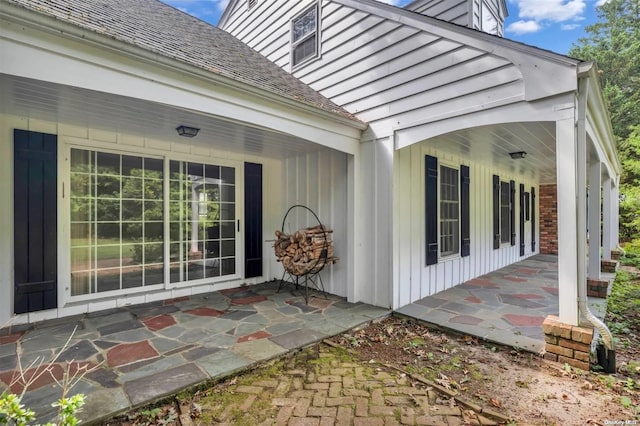 view of exterior entry featuring a patio