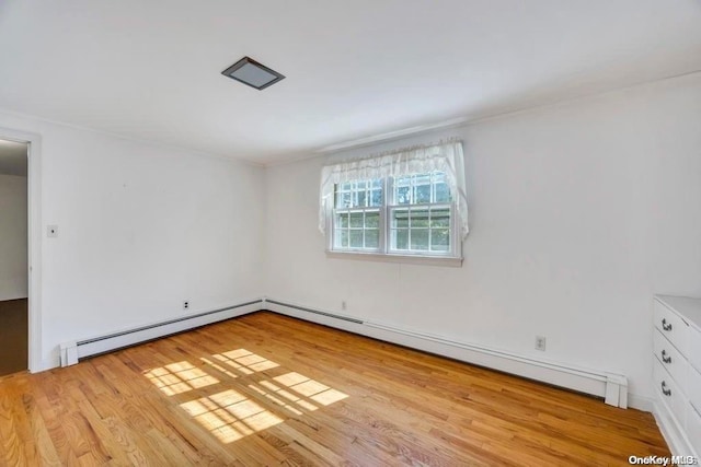 unfurnished room featuring light hardwood / wood-style floors and a baseboard radiator