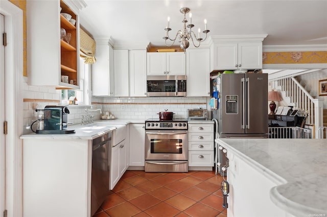 477 Montauk Hwy, Westhampton Beach, NY 11978 - kitchen featuring appliances with stainless steel finishes, ornamental molding, white cabinets, and tasteful backsplash