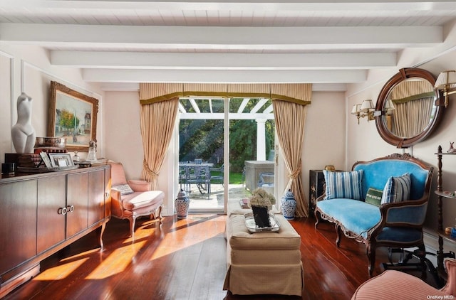 living area with beam ceiling, dark hardwood / wood-style floors, and a healthy amount of sunlight