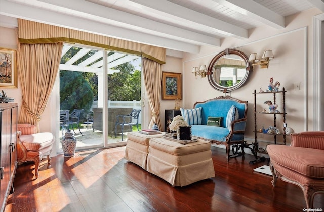 sitting room with a wealth of natural light, beamed ceiling, and dark wood-type flooring