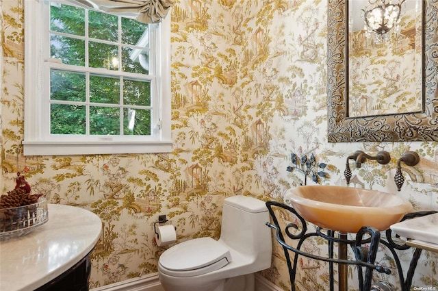 477 Montauk Hwy, Westhampton Beach, NY 11978 - bathroom featuring wallpapered walls, toilet, baseboards, and a sink