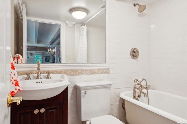 bathroom featuring vanity, a bath, tile walls, and toilet