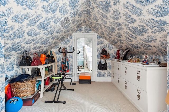 workout room featuring carpet and vaulted ceiling