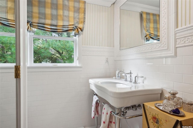 bathroom with crown molding and tile walls