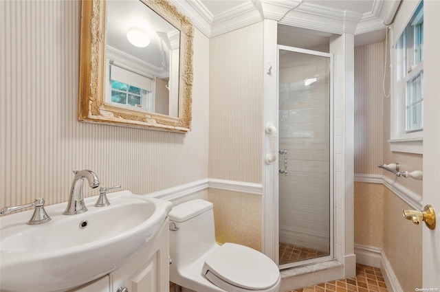 bathroom featuring toilet, a shower with shower door, crown molding, and sink