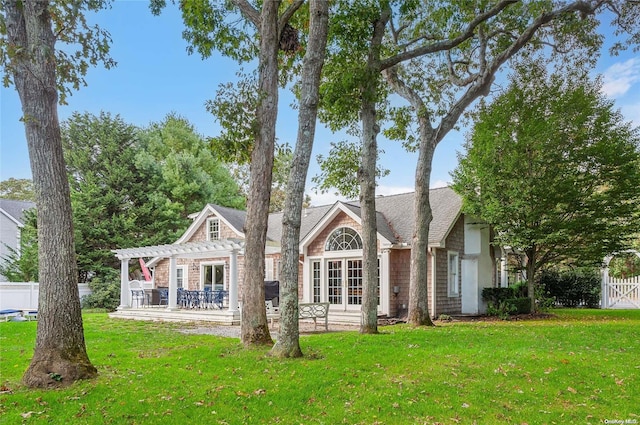 exterior space featuring a pergola and a lawn