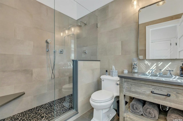 bathroom with decorative backsplash, toilet, tiled shower, and tile walls