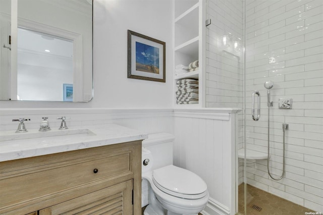 bathroom with tile patterned floors, toilet, an enclosed shower, and vanity