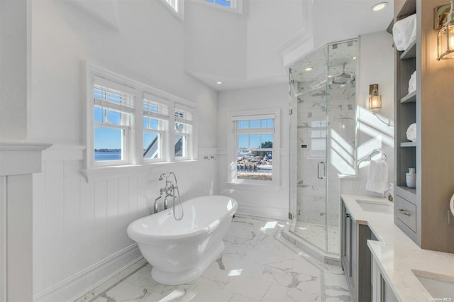 bathroom with vanity, wood walls, and shower with separate bathtub