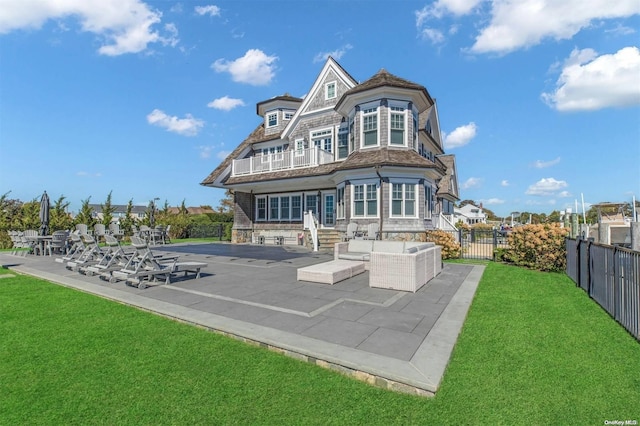 rear view of property with an outdoor hangout area, a yard, and a patio