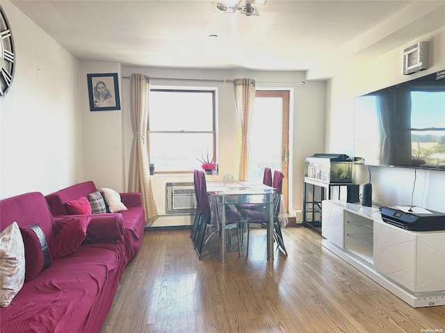 dining room with hardwood / wood-style flooring and a wall mounted air conditioner