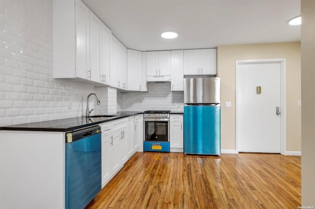 kitchen featuring sink, white cabinets, light wood-type flooring, and appliances with stainless steel finishes