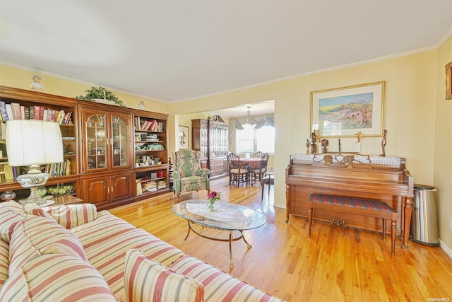 living room featuring light hardwood / wood-style flooring and crown molding