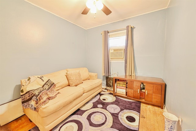 living room featuring light hardwood / wood-style flooring, ceiling fan, and cooling unit