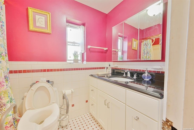 bathroom featuring vanity, toilet, tile walls, and curtained shower