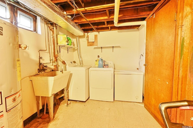 laundry room with gas water heater and washing machine and dryer