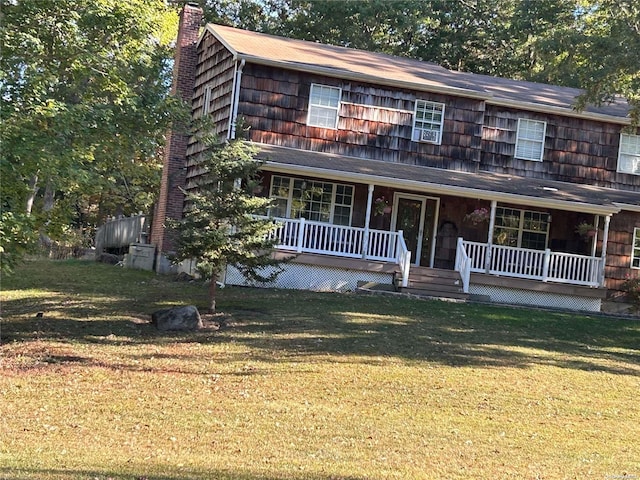 view of front of property with covered porch and a front yard