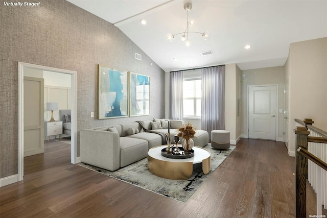 living room featuring hardwood / wood-style floors, high vaulted ceiling, and a chandelier