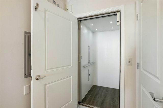 interior space with wood-type flooring and elevator