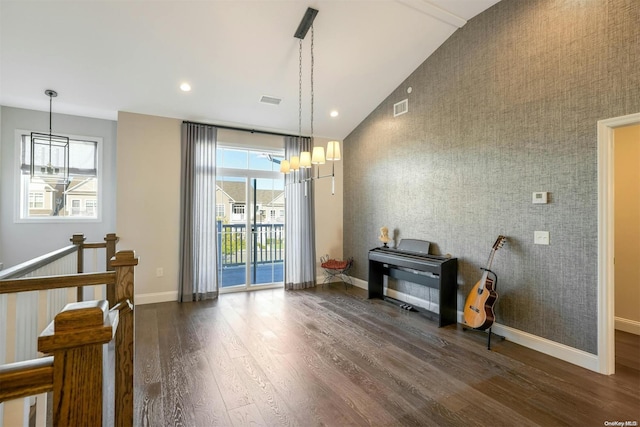 miscellaneous room with a chandelier, dark hardwood / wood-style flooring, and high vaulted ceiling