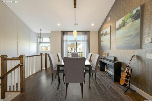 dining room with dark wood-type flooring and lofted ceiling