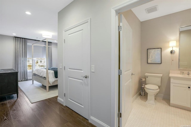 bathroom featuring hardwood / wood-style floors, vanity, and toilet