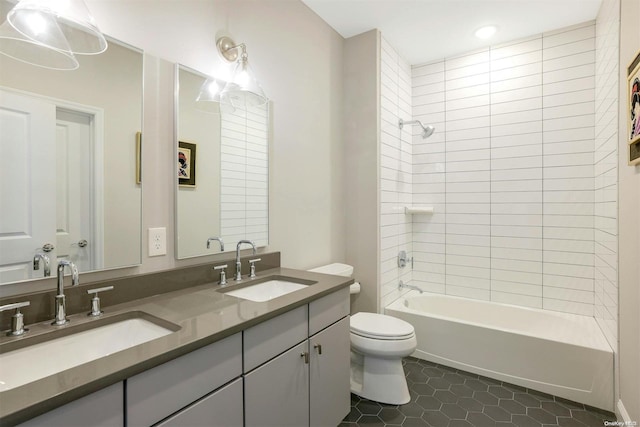 full bathroom with tile patterned flooring, vanity, toilet, and tiled shower / bath