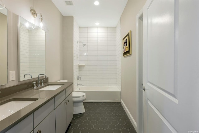 full bathroom with tile patterned flooring, vanity, toilet, and tiled shower / bath